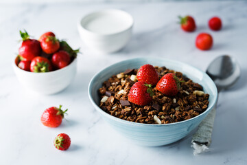 Chocolate nuts oatmeal granola with chocolate slices in a bowl