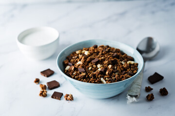 Chocolate nuts oatmeal granola with chocolate slices in a bowl