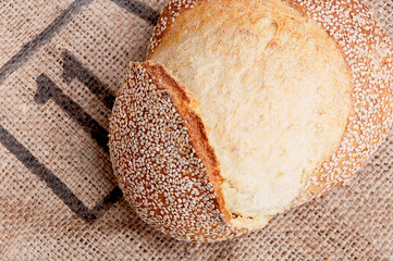Rustic Artisan bread Loaf  with sesame seeds on Burlap Background