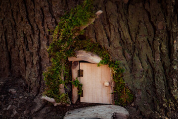 eco-friendly wooden house concept-symbol hanging on a tree