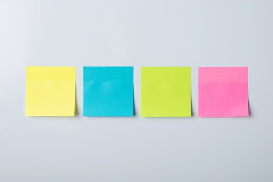 Four colorful sticky notes on a whiteboard