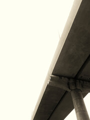 black and white shot of under bridge