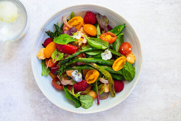 Summer panzanella salad with tomatoes, raspberries, basil and red onion