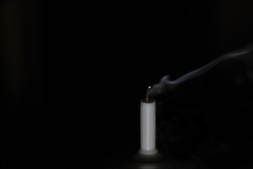 Blown candle on black background 