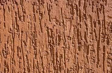 Brown decorative relief plaster. stucco wall. Brown background of the wall.