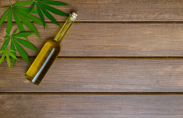 CBD oil on wooden background. The concept of a natural and organic product. Medical marijuana cbd oil.
