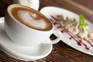 a white ceramic cup of cappucino as a coffee break concept