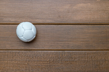 Lacrosse white ball on wooden background. Lacross is a team sport - obrazy, fototapety, plakaty