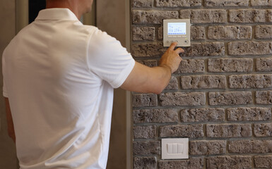 Man using smart wall home control system
