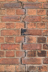 Close Up of Old Weathered Brick Wall with Large Central  Vertical Crack 