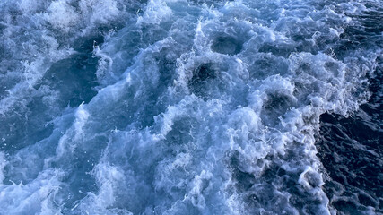 Fototapeta na wymiar Seawater surface. White foam waves texture as a natural background.