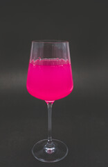 Pink drink in wine glass