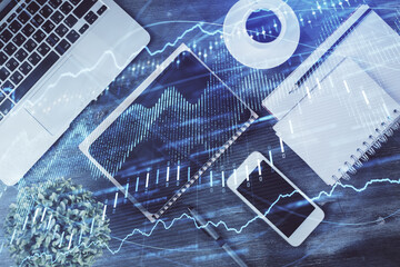 Double exposure of forex chart hologram over desktop with phone. Top view. Mobile trade platform concept.