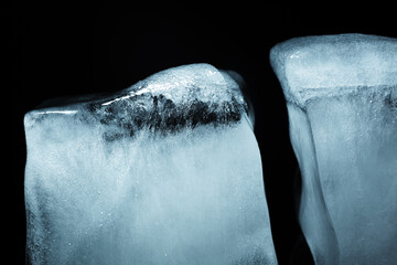 Closeup of cracked ice texture on an ice cube. Studio macro shot.