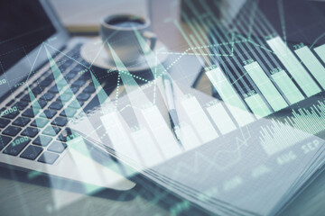 Double exposure of forex chart drawing and desktop with coffee and items on table background. Concept of financial market trading