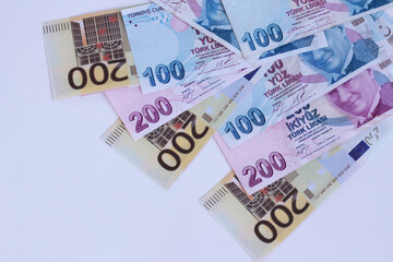 Turkish Banknotes and Two Hundred Euro Banknotes designed together on white surface with copy space