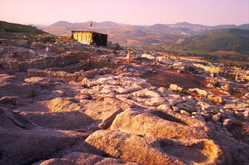 Young caucasian woman resting in the ancient ruins of Perperikon in Bulgaria.