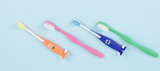 Hygiene and health care concept.Multicolored children's tooth brushes on blue backgound.Banner