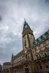 Fototapeta na wymiar The famous Hamburg town hall with dramatic clouds at market square Hamburg, Germany.