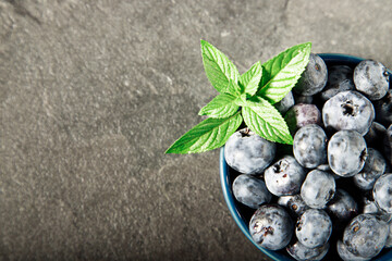Blueberry on wooden table background. Ripe and juicy fresh picked blueberries closeup. Berries closeup
