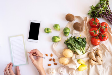 hands and mobile phone for searching online app for recipe , nutrition, diet and grocery shopping.