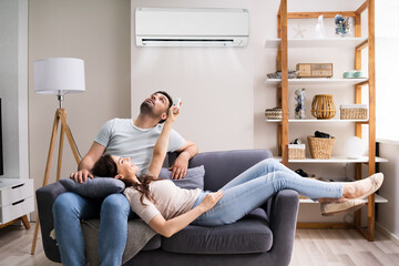Happy Woman Holding Air Conditioner Remote