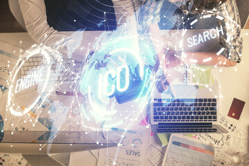 Double exposure of man and woman working together and crypto theme hologram drawing. Computer background. Blockchain concept. Top View.