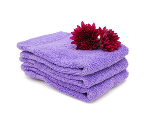 Purple towels and daisy flowers on white background