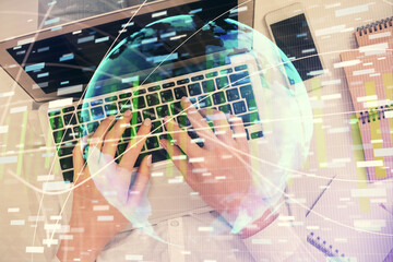 Double exposure of woman hands working on computer and financial theme hologram drawing. Top View. Business concept.