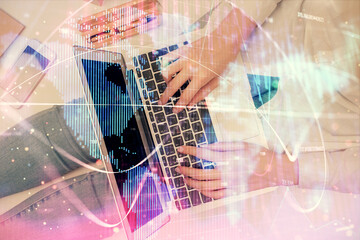 Double exposure of woman hands working on computer and financial theme hologram drawing. Top View. Business concept.