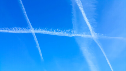 Condensation trails in a blue sky. Nature background