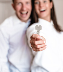 Happy married couple holding keys. Couple in love. Smile man and woman. Celebration. People. 
