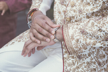 Obraz na płótnie Canvas Indian Punjabi Sikh groom's wedding outfit and jewellery close up