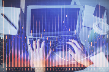 Double exposure of woman hands typing on computer and forex chart hologram drawing. Stock market invest concept.