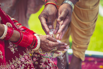 Indian Hindu wedding ceremony ritual items, hands and decorations close up
