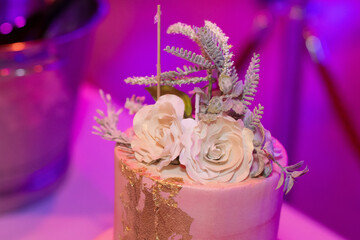 Indian wedding reception cake with flowers on top