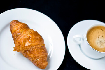 A fresh croissant with morning coffee