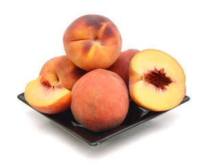 Peaches isolated in black plate on white