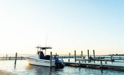 Fototapeta premium Sunset background with boats docked in the harbor, Long Beach Island vacation destination