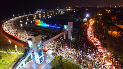 Fotobehang Aerial view of nighttime fountain attraction at Surabaya bridge, East Java, Indonesia which attracts local tourists  © DODO HAWE