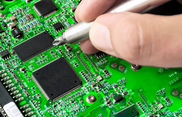 repairing a printed circuit board. Micro technology and repairs. Electronic components and...
