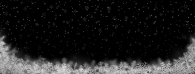 Christmas background of snowflakes of different shapes, sizes, blur and transparency on black background
