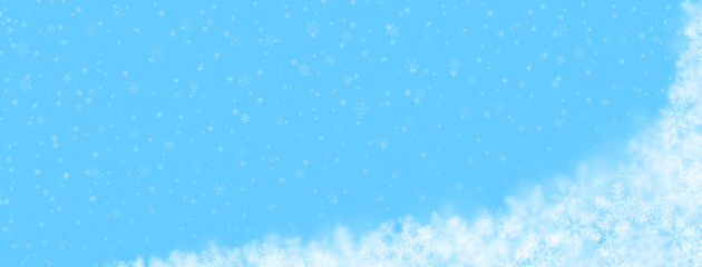 Christmas background of snowflakes of different shapes, sizes, blur and transparency on light blue background