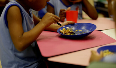 salvador, bahia / brazil - march 22, 2019: child is seen eating school lunch in criche in the city of Salvador. © Joa Souza