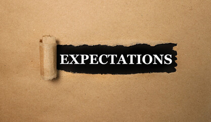 expectations. text on black paper, on torn paper