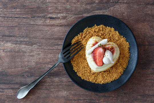 Single Serving Of Heart Shaped Creamy Italian Cheesecake On Graham Cracker Crumbles
