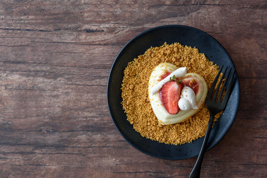 Single Serving Of Heart Shaped Creamy Italian Cheesecake On Graham Cracker Crumbles
