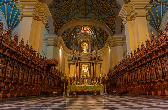 Interior of the Lima Metropolitan Cathedral with the congregation seats and Virgin Mary in baroque style with the main altar, Peru.