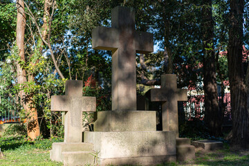 crosses made of cement against green tree background