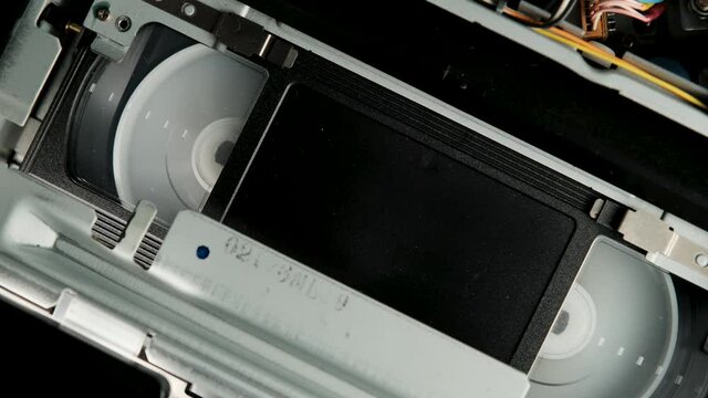Fast rewind of VHS old vintage tape cassette without sign. retro VCR player. Old vintage tape on the video, audio tape recorder or player.